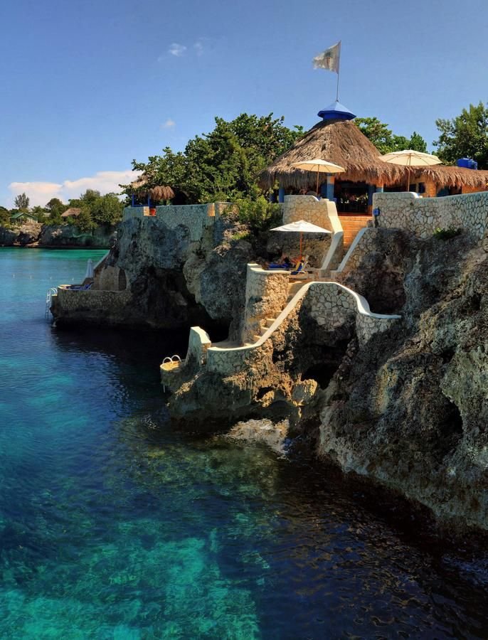 The Caves, a unique cliffside resort in Jamaica offering intimate accommodations and dining.